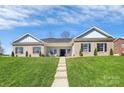Beautiful brick home with a well-maintained lawn and inviting entrance featuring classic architectural details at 609 Rosemore Pl, Rock Hill, SC 29732