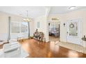 Sunlit foyer features hardwood floors, an adjacent dining area, and a view into a bright, open-concept space at 6126 Castlecove Rd, Charlotte, NC 28278