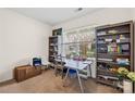 Bright home office with a large window, built-in shelving, and a neutral color scheme for a productive workspace at 6126 Castlecove Rd, Charlotte, NC 28278