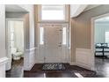 Bright foyer featuring dark wood floors, white trim, and natural light, creating a welcoming entrance at 6423 Red Maple Dr, Charlotte, NC 28277