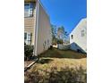 View of the backyard showcasing the proximity to a neighboring house and a glimpse of a wooden fence at 719 Mountain Quail Dr # 34, Charlotte, NC 28216
