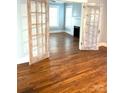 Open living room featuring gleaming hardwood floors and glass french doors at 723 S Confederate Ave, Rock Hill, SC 29730