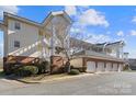 Low-angle view of a well-maintained home featuring an attached garage at 8923 Meadow Vista Rd, Charlotte, NC 28213