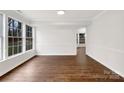 Empty, light-filled dining room with hardwood floors, a neutral palette, and a classic aesthetic at 9203 Christina Marie Ct, Charlotte, NC 28213