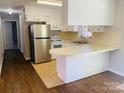 Bright kitchen featuring stainless steel appliances, white cabinets, and a functional breakfast bar at 111 Dove Cir, Statesville, NC 28625
