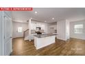 Open-concept kitchen with white cabinetry, granite counters, stainless appliances, and wood floors at 11217 Cardinal Creek Ave, Charlotte, NC 28215