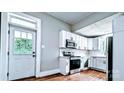 Bright kitchen featuring white cabinets, stainless steel appliances and a door to the outside at 113 Brawley St, Chester, SC 29706