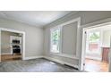 Carpeted living room with windows and doorways, offers seamless flow and lots of light at 113 Brawley St, Chester, SC 29706