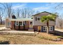 Classic home with brick and siding and a complementary green roof at 121 Alexis Forest Dr, Stanley, NC 28164