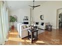 Spacious living room with hardwood floors, a fireplace, and neutral decor at 12508 Asbury Chapel Rd, Huntersville, NC 28078
