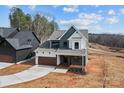 New construction home showing the side yard, large driveway, and professional landscaping at 127 Mills Garden Rd, Statesville, NC 28625