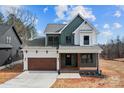 A charming two-story home with a covered porch, a 2 car garage and professional landscaping at 127 Mills Garden Rd, Statesville, NC 28625