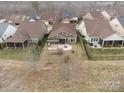 Aerial view of the home showcasing the backyard patio with firepit and a pergola at 131 Chimney Rock Ct, Denver, NC 28037