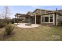 Backyard with a screened-in porch, stone patio, pergola, outdoor kitchen, and a fire pit at 131 Chimney Rock Ct, Denver, NC 28037