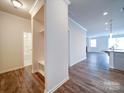 Bright hallway featuring hardwood floors that lead to the kitchen and living area at 15040 Cordelia Dr, Charlotte, NC 28278
