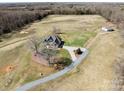Aerial view of home with lush lawn, long driveway and trees, offering a beautiful view of property at 16160 Hopewell Church Rd, Midland, NC 28107