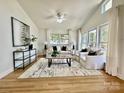 Spacious living room featuring a large windows, hardwood floors, and lots of natural light at 1713 Archdale Dr, Charlotte, NC 28210