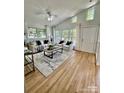 Bright living room with vaulted ceilings, large windows, and hardwood flooring and neutral colors at 1713 Archdale Dr, Charlotte, NC 28210