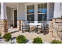 Cozy covered front porch with rocking chairs and stone pillars, a welcoming outdoor space at 187 Tetcott St, Mooresville, NC 28115