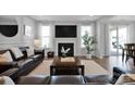 Comfortable living room with modern decor, a fireplace, and plenty of natural light at 187 Tetcott St, Mooresville, NC 28115