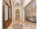 Grand foyer with a chandelier, elegant tile flooring, and a decorative front door at 235 Blue River Rd, Clover, SC 29710