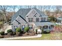 A beautiful brick home seen from above, with a large roof and well-maintained landscaping at 2689 Wingrave Nw St, Concord, NC 28027