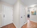 Inviting entryway with wood floors, neutral paint, and access to other rooms in the home at 2727 Tiergarten Ln, Charlotte, NC 28210