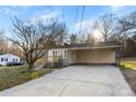 Single story home with gray brick, a concrete driveway, carport and new wood porch at 2729 Springbrook Cir, Gastonia, NC 28052