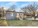 Charming single-story home with gray brick, a wooden porch, and mature landscaping at 2729 Springbrook Cir, Gastonia, NC 28052