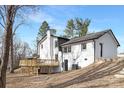 Back exterior view of a white painted brick home with a new wooden deck at 301 Dollar Cir, Charlotte, NC 28270