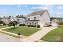Well-maintained home with a detached two-car garage, lush lawn, and a charming curb appeal at 3173 Delaware Dr, Denver, NC 28037