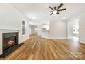 Spacious open-concept living room with a fireplace, hardwood floors, and a ceiling fan at 326 Lewis Ferry Rd, Statesville, NC 28677