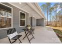 A covered patio featuring a cozy seating area perfect for enjoying the outdoors and relaxation at 326 Lewis Ferry Rd, Statesville, NC 28677