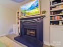 Close-up view of the painted fireplace with a decorative mantle and built-in cabinets in the living room at 3300 Selwyn Farms Ln # 5, Charlotte, NC 28209