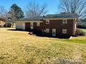 Backyard view of a brick home featuring a well-maintained lawn at 344 Circleview Dr, Shelby, NC 28150