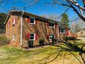 Side view of a brick home with red shutters and lush green lawn at 344 Circleview Dr, Shelby, NC 28150