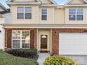 Inviting townhouse exterior with brick accents, brown shutters, and a two car garage at 3465 Caldwell Ridge Pkwy, Charlotte, NC 28213
