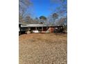 Charming one-story brick home with a cozy front porch and a well-manicured lawn at 37254 Barnhardt Rd, New London, NC 28127