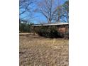 A side view of a brick home that needs some landscaping at 37254 Barnhardt Rd, New London, NC 28127
