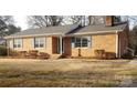 Beautiful brick home with light blue shutters and a cozy, landscaped front yard at 501 Catawba N Cir, Matthews, NC 28104