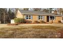 Inviting brick home featuring tidy landscaping and blue shutters at 501 Catawba N Cir, Matthews, NC 28104