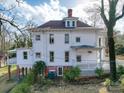 Spacious two-story home with a covered deck, classic details, and a lush yard at 505 Camden Rd, Wadesboro, NC 28170