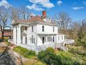 Elegant two-story home featuring a porch, white columns, and inviting outdoor spaces at 505 Camden Rd, Wadesboro, NC 28170