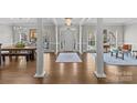 Elegant foyer with hardwood floors, decorative columns, and a chandelier at 5618 Camilla Dr, Charlotte, NC 28226