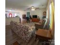 Comfortable living room with hardwood flooring, ceiling fan, with easy access to the kitchen and dining area at 648 E Ketchie St, China Grove, NC 28023