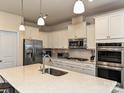 Stylish kitchen featuring a large island, stainless steel appliances and pristine white cabinetry at 7015 Walnut Branch Ln, Charlotte, NC 28277