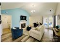 Bright living room with vaulted ceilings, fireplace, and cozy seating arrangement at 7204 Cranswick Pl, Charlotte, NC 28227