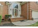 Elegant front entrance with brick steps, sidelights, and an arched window above the door at 8731 Sheltonham Way, Charlotte, NC 28216