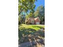 Lovely brick home with a manicured front yard and an attached two car garage at 8731 Sheltonham Way, Charlotte, NC 28216