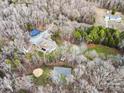 An aerial view of the home, featuring a basketball court and solar panels at 10000 Blossom Dr, Concord, NC 28025